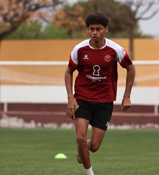 Murcia Football Academy player running on pitch during training