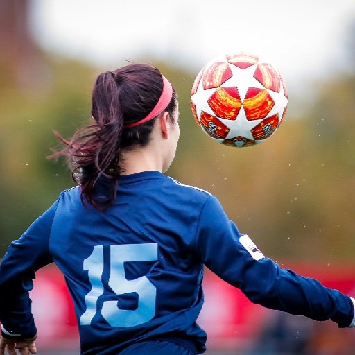 girls football trials player heading ball