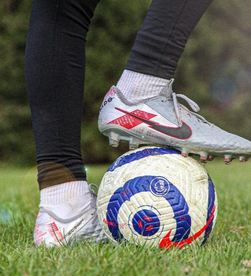 player wearing football boots with studs on grass
