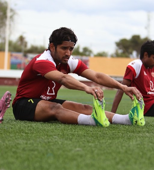 soccer boarding school player stretching at murcia football academy