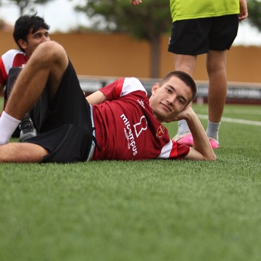young football player resting after tackling drill