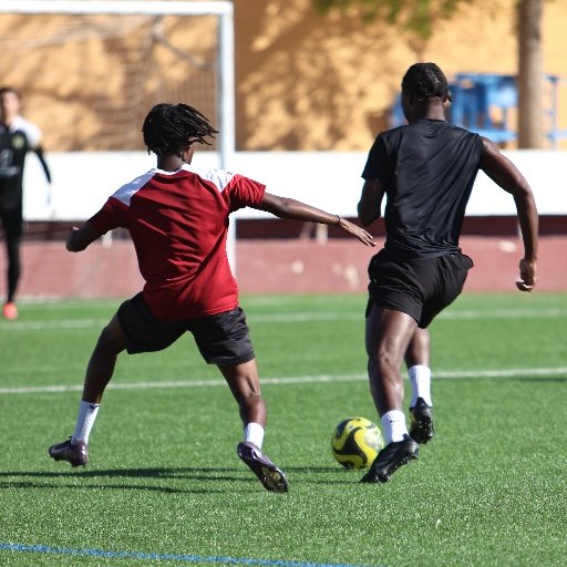 football players competing for ball in training drill