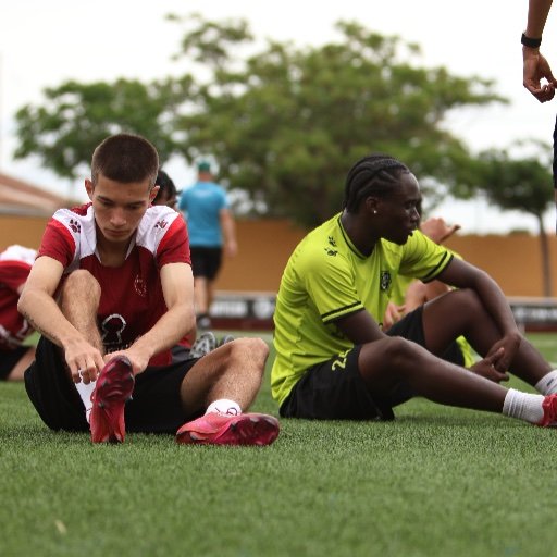 murcia football academy players stretching before ball control drills