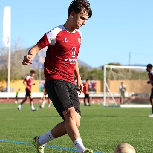 murcia football academy player passing the ball during training in spain